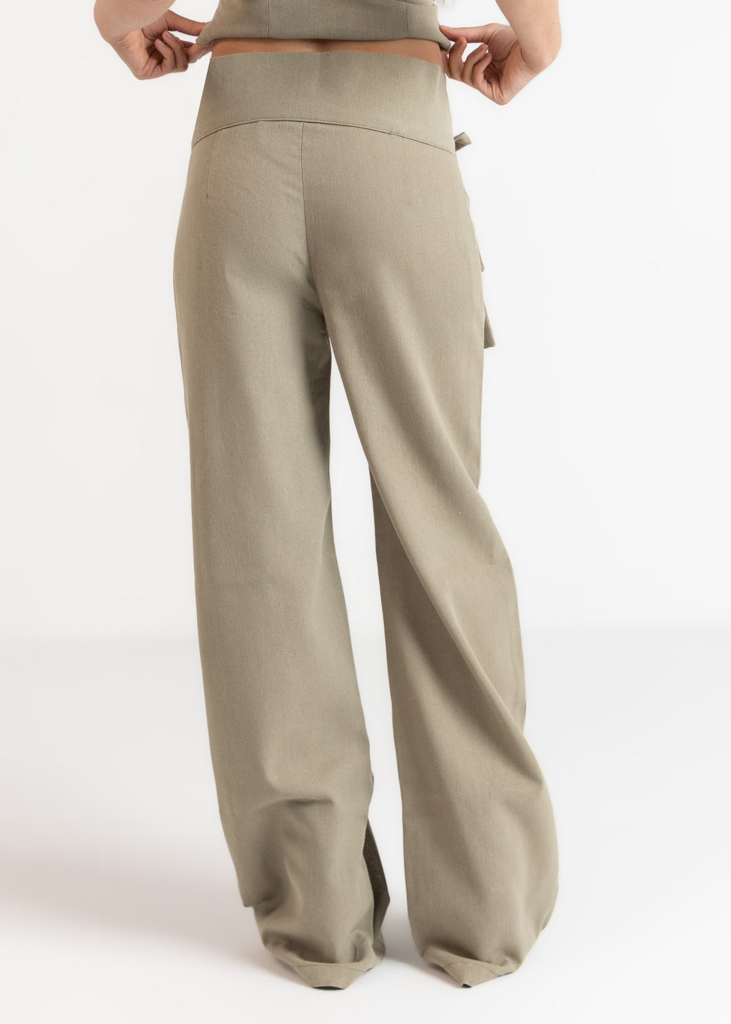 Beige wide-leg pants worn by a person on a white background