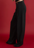 Black wide-leg pants on a red background