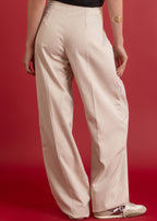 Beige pants worn by a person on a red background